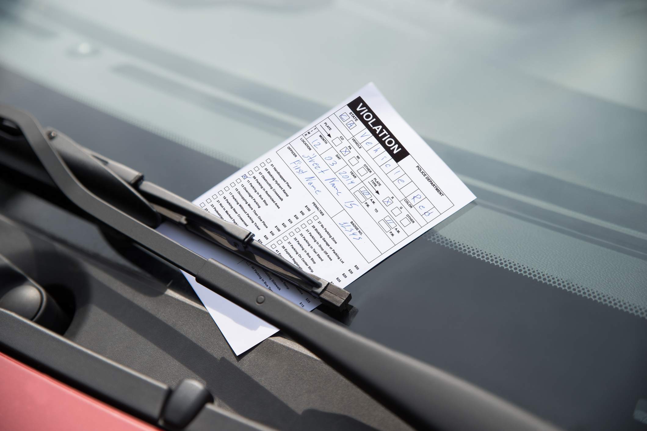 traffic ticket on windshield of car